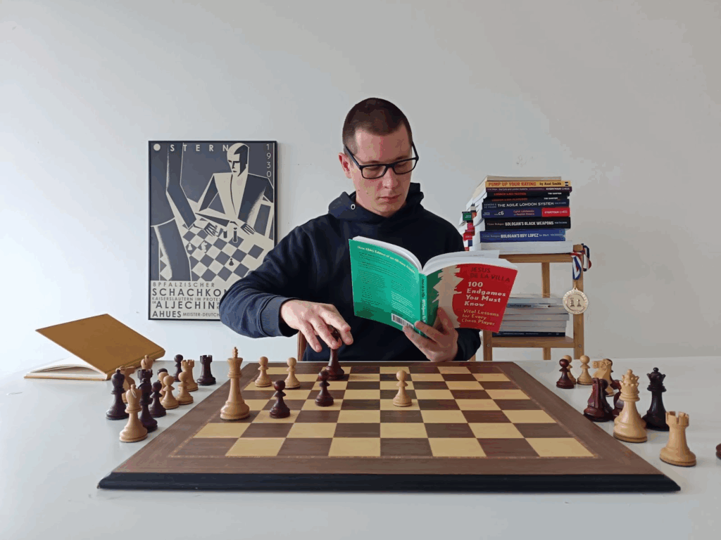 A chess player reading 100 Endgames You Must Know and analyzing endgame positions over a chess board.