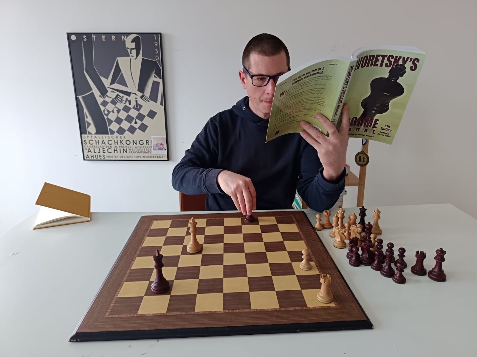 Stjepan Tomić reading Dvoretsky's Endgame Manual and solving positions.